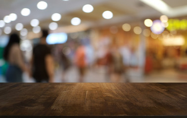 Empty dark wooden table in front of abstract blurred bokeh background of restaurant . can be used for display or montage your products.Mock up for space.