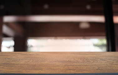 Empty dark wooden table in front of abstract blurred bokeh background of restaurant . can be used for display or montage your products.Mock up for space.