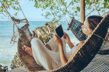 Woman relaxing in hommack on the beach