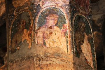 Cave 10: Paintings on Pillars. Seated and standing Buddha images in teaching attitude Ajanta Caves,...