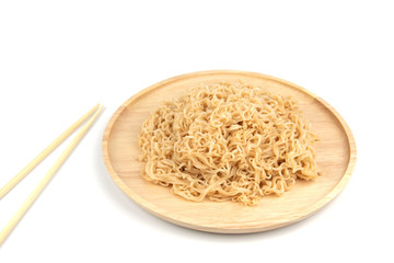 Instant noodles on a wooden plate on a white background