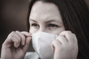 Stop the infection, woman wearing medical mask on the street protection against virus, concept of pollution