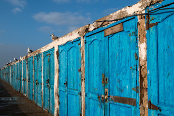 Line of blue doors on an old building