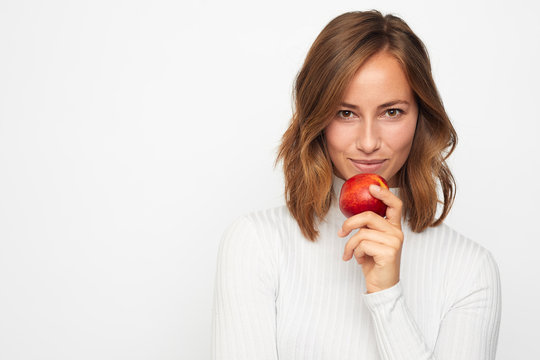 portrait of happy young woman with red apple