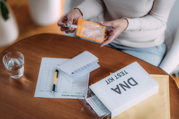 Senior Woman Preparing DNA Genetic Test Kit © Microgen