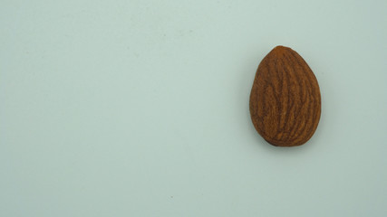 Raw almond isolated on white background.