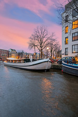 City scenic from Amsterdam at the Amstel in the Netherlands at sunset