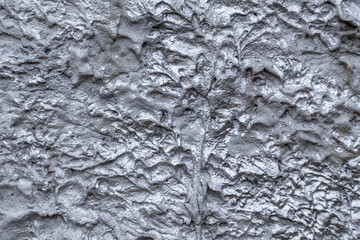 Abstract silver color painted on grunge rough surface of stucco concrete wall. Good for  texture background and wallpaper