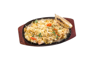 Casserole with salmon, potatoes and slice of lemon in metal pan isolated on white background