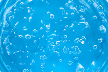 Transparent blue gel with oxygen bubbles texture close up. Abstract cosmetic background 