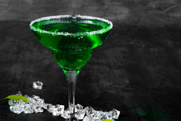 Beautiful alciohol cocktail on dark stone table