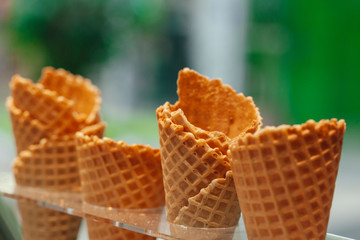 Four ice cream cones in a row close up