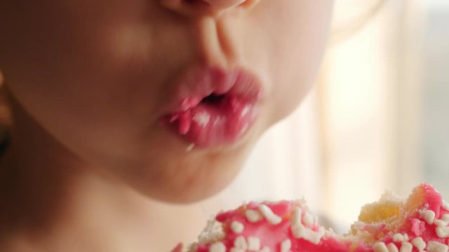 little girl eating red, pink donut, doughnut, macro, close