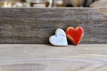 Two wooden hearts with texture isolated on old wooden background. Love, wedding, Valentine's Day concept