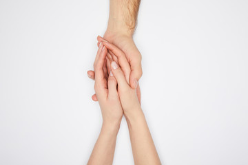 top view of couple holding hands isolated on white