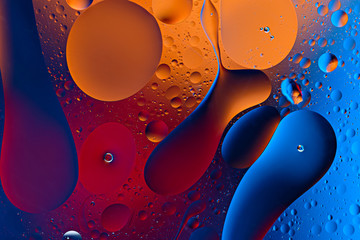 drops and smears on colored background of oil drops on water surface