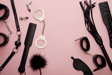 top view of black sex toys on pink background
