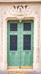 Paris, an old wooden door, with a head carved on the lintel, typical building in the Marais