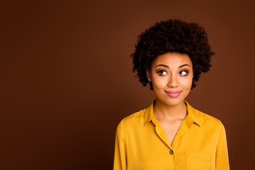 Obraz na płótnie Canvas Closeup photo of beautiful pretty dark skin wavy lady positive good mood look side empty space interested have creative idea wear yellow shirt isolated brown color background