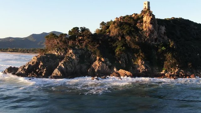 Drone aerial view of Torre Salinas sea promontory at sunrise, Sardinia, Italy