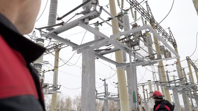 Job works by professional industrial energy person or electrician on power plant. Heavy industry worker in safety hardhat circuiting switching of electric equipment. Male people on engineer inspection