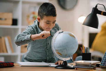 Cute little boy doing homework. Child learning foe school. 