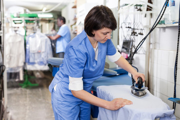 Obraz premium Girl ironing in laundry