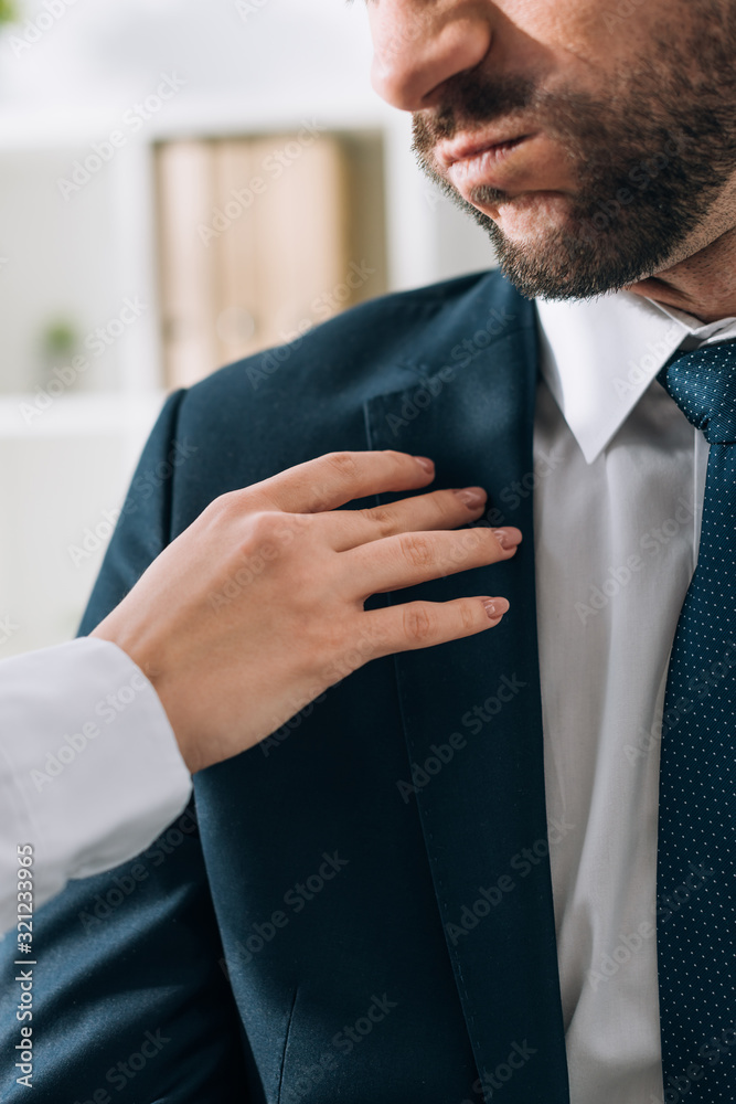 Wall mural cropped view of secretary touching businessman in office