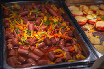 Fried sausages with vegetables in a self-service restaurant