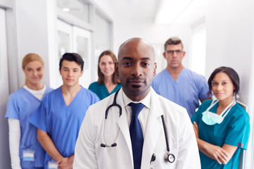 Portrait Of Multi-Cultural Medical Team Standing In Hospital Corridor