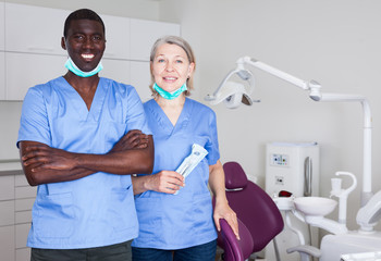 Dentist with assistant in the workplace in clinic