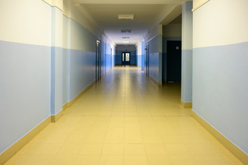 Photo of a corridor in a building with doors