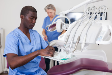 Portrait of male dentist and assistant in workplace at clinic