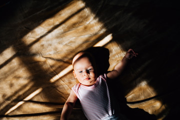 Beautiful light and shadow on a top view shot of a six months old baby