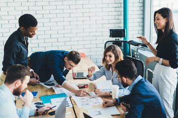 Adult diverse coworkers having fun during conference in workplace