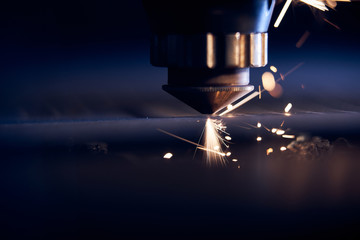 CNC Laser cutting of metal close up, modern industrial technology. Small depth of field
