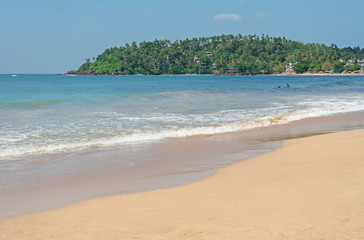 Ocean island sand beach landscape with blue water, Mirissa, Sri Lanka