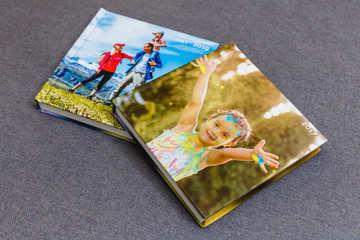 Fototapeta na wymiar Photobook album on deck table with travel photos