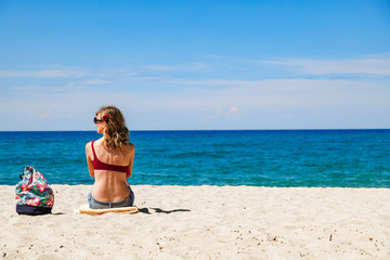 Woman enjoying on a sandy tropical beach.