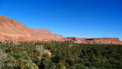 Bright landscape of Morocco, breathtaking curves of mountains, stunning combination of hills & farm land,inadvertent distribution of houses & huts, raw impression of pure nature.
