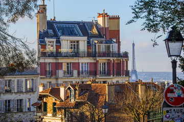 Fototapeta na wymiar FEBRUARY 1, 2019 - PARIS, FRANCE: Panoramic view over Paris from Montmartre, apartment buildings in forefront, Eiffel tower in distance