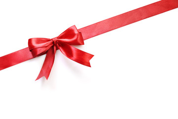 Shiny red satin ribbon and bow isolated on white background