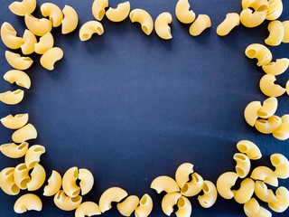 raw pasta on black background texture