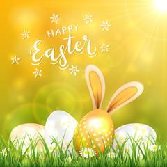 Golden Easter Eggs in Grass and Rabbit Ears