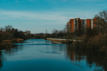 Blue river in the city  with the reflection of buildings.Urban landscape 