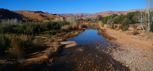 Bright landscape of Morocco, breathtaking curves of mountains, stunning combination of hills & farm land,inadvertent distribution of houses & huts, raw impression of pure nature.