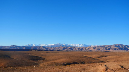 Bright landscape of Morocco, breathtaking curves of mountains, stunning combination of hills & farm land,inadvertent distribution of houses & huts, raw impression of pure nature.