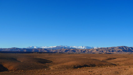 Bright landscape of Morocco, breathtaking curves of mountains, stunning combination of hills & farm land,inadvertent distribution of houses & huts, raw impression of pure nature.
