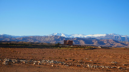 Bright landscape of Morocco, breathtaking curves of mountains, stunning combination of hills & farm land,inadvertent distribution of houses & huts, raw impression of pure nature.