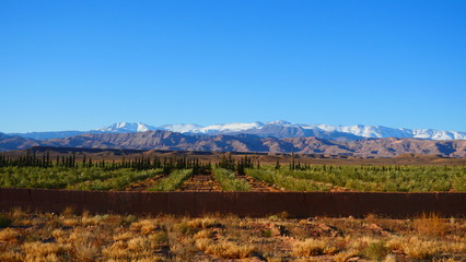 Bright landscape of Morocco, breathtaking curves of mountains, stunning combination of hills & farm land,inadvertent distribution of houses & huts, raw impression of pure nature.